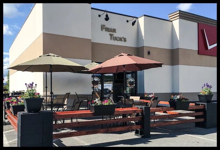 Friar Tuck's Hoagie House storefront with outdoor patio, umbrellas and flower planters